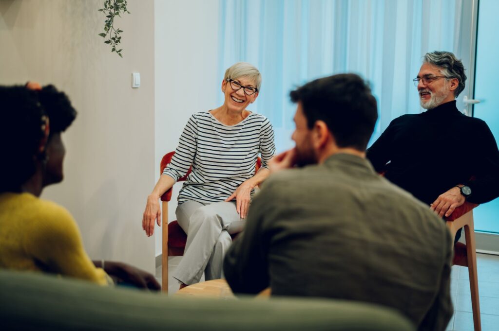 senior woman smiling and laughing during a dementia awareness session 