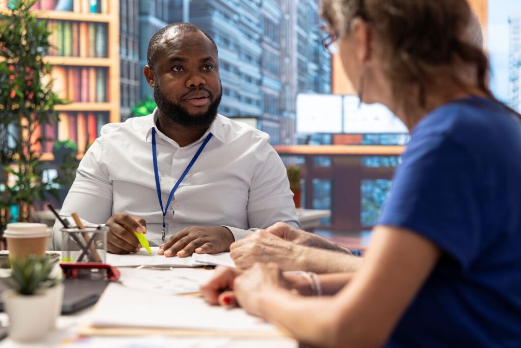 care worker and manager sat at a desk together, meeting to outline personal and professional development goals